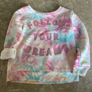 Toddler tie-dye sweatshirt. Featuring on the front side is “Follow your dreams.”
